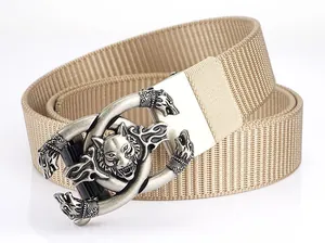 Close-up of khaki nylon belt with wolf head buckle and textured canvas weave fabric