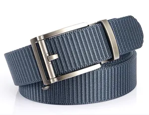 Detail of navy blue nylon woven belt with brushed metal automatic buckle on white surface