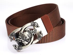 Close-up of wolf embossed zinc alloy buckle and durable brown tactical nylon belt strap
