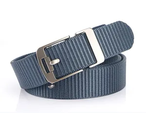 Detail of navy blue woven men's belt with silver-gray brushed metal buckle texture