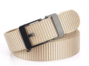Macro detail of khaki woven nylon belt with matte black metal buckle on white background
