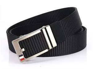 Detail of black nylon woven belt featuring a silver automatic buckle with tricolor stripes