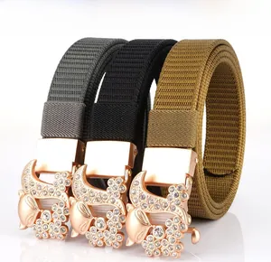 Close-up of woven nylon belts with rose gold rhinestone-encrusted fox buckles in three colors