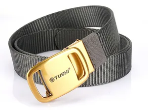 Close-up of gray nylon belt with golden TUSHI automatic metal buckle and lion head logo