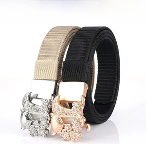 Detail of fox buckle belts with rhinestones in khaki and black nylon canvas fabric