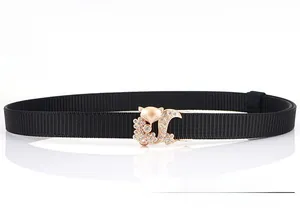 Detail of fox-shaped gold buckle with crystal rhinestones on a black woven nylon belt