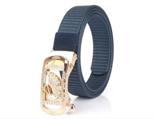 Close-up of golden alloy buckle with swan crystal and blue nylon woven belt texture