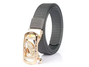 Close-up of grey nylon belt with luxury gold swan automatic buckle and rhinestones