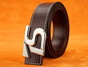 Dettaglio cintura in pelle marrone scuro con cuciture bianche e fibbia a S argento
