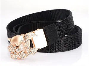 Detail of nylon woven belt featuring a rose gold fox buckle with sparkling rhinestones