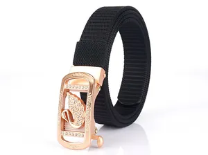 Detail of rose gold automatic buckle with sparkling swan inlay on black nylon belt