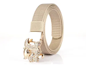 Close-up of beige woven nylon belt with a rhinestone-studded gold fox buckle