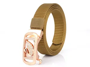 Close-up of rose gold swan buckle with sparkling rhinestones on khaki nylon belt