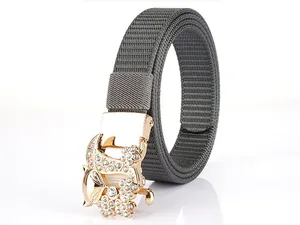 Detail of grey nylon belt featuring a gold fox buckle encrusted with white rhinestones