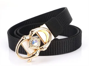Detail of black nylon belt with golden four-leopard buckle and colorful gemstone