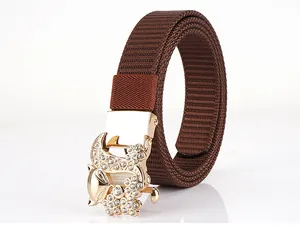 Detail of a brown nylon woven belt with a gold fox buckle inlaid with sparkling rhinestones
