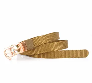 Detail view of khaki nylon belt with zinc alloy gold buckle and star emblem