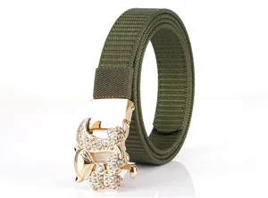 Detail of army green nylon woven belt with crystal fox buckle and golden finish