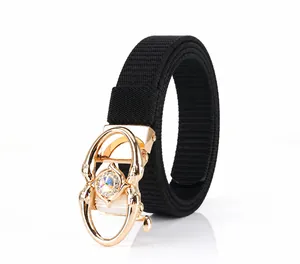 Detail of black nylon belt with golden spider buckle featuring colorful rhinestones