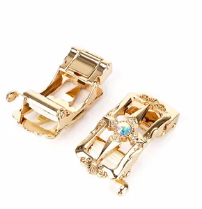 Close-up of zinc alloy automatic buckles with gold finish and star engraving details
