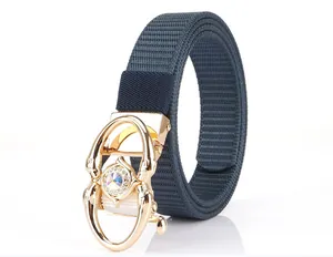Detailed close-up of golden belt buckle with crystal inlay and blue nylon strap
