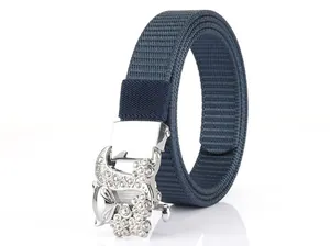 Close-up of sparkling fox-shaped rhinestone buckle on a navy blue nylon woven belt