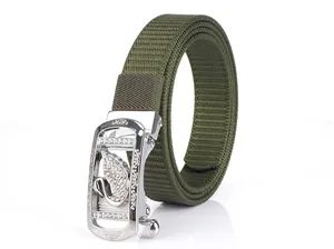 Detail of army green nylon belt featuring silver automatic buckle with swan crystal design