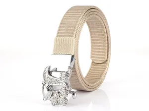 Macro shot of silver fox buckle with sparkling rhinestones on beige nylon belt