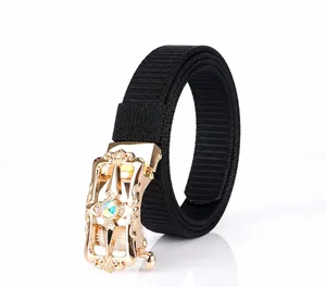 Close-up of black nylon canvas belt with ornate gold buckle and embedded gemstone