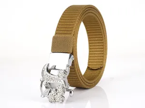 Detail of khaki nylon woven belt with a luxury silver buckle featuring white rhinestones