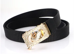 Detail of golden alloy buckle with swan engraving and blue diamond on nylon belt