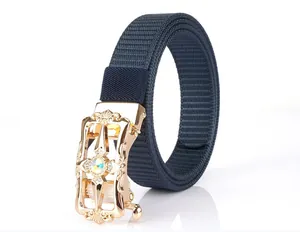 Detail of dark blue nylon belt featuring ornate golden buckle with gemstone inlay
