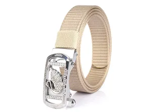 Detail of khaki nylon belt featuring a silver buckle with a rhinestone swan motif