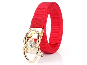 Detail of red woven nylon belt featuring a luxurious gold buckle with rhinestones