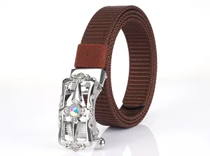 Close-up of brown nylon canvas belt with ornate silver buckle and central rhinestone