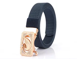 Detailed shot of rose gold swan buckle with rhinestones on navy nylon woven belt