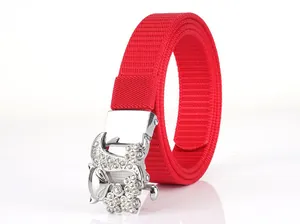 Detail of red nylon belt with a crystal-encrusted fox-shaped metal buckle on white background