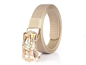 Detail of beige nylon woven belt featuring a gold automatic buckle with crystal inlay