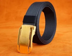 Detail of blue nylon woven belt with matte gold automatic buckle and eagle logo