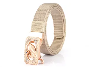Detail of rose gold alloy buckle with swan logo and khaki nylon web belt strap