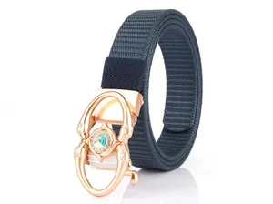 Detail of navy blue woven belt featuring a rose gold buckle with a central rhinestone