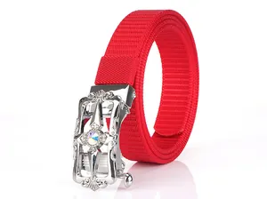 Detail of red nylon canvas belt with vintage floral silver buckle and inlaid rhinestone