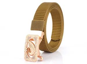 Detailed close-up of khaki nylon belt featuring a crystal swan automatic metal buckle