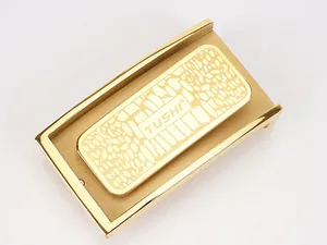 Detail view of the TUSHI gold automatic belt buckle featuring a matte textured finish