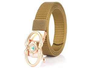 Close-up of khaki woven nylon belt with rose gold buckle and dolphin rhinestone detail