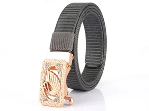 Detailed view of grey nylon belt with rose gold swan buckle and intricate floral embossing