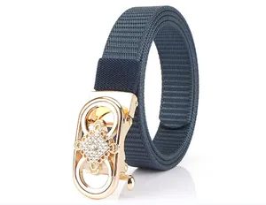 Detailed macro of a dark blue nylon belt with a gold rhinestone-encrusted automatic buckle