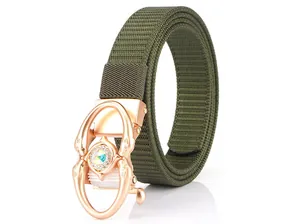 Detail of army green woven belt featuring a rose gold dolphin buckle with sparkling crystals