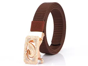Detail of rose gold buckle with swan crystal relief and brown nylon webbed strap