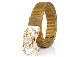 Close-up of brown nylon belt with gold-tone buckle featuring a sparkling rhinestone pattern